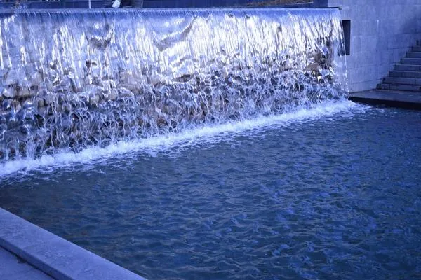 Beautiful Cascading Flowers Pouring Over the Side of a Garden Wall image 4